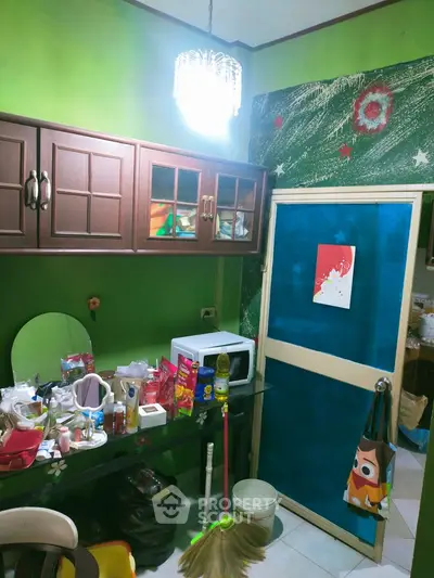 Cozy kitchen with vibrant green walls and wooden cabinets