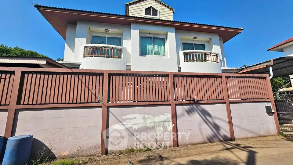 Charming two-story house with unique balcony design and spacious exterior.