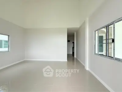 Spacious empty room with large windows and glossy tiled floor, perfect for customization.
