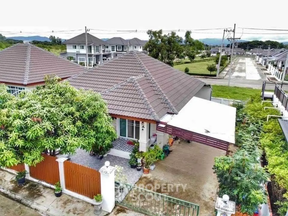 Charming suburban house with spacious driveway and lush greenery in a peaceful neighborhood.