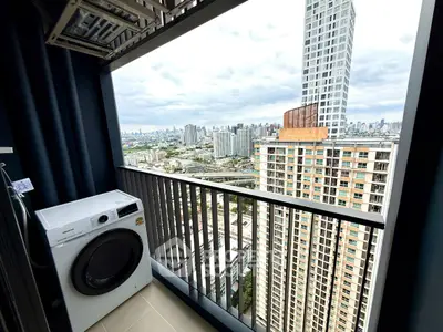 High-rise balcony with washing machine and stunning city view