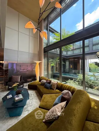 Luxurious living room with high ceilings, large windows, and modern decor in a contemporary home.