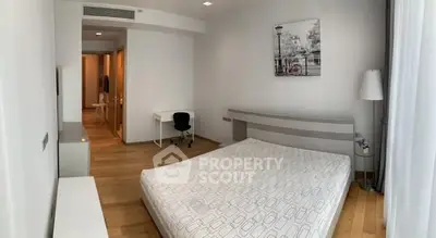 Spacious modern bedroom with wooden flooring and minimalist decor