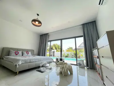 Spacious bedroom with pool view and modern decor