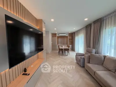 Spacious modern living room with large TV and elegant decor
