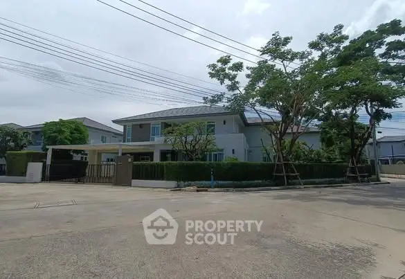 Spacious modern house with lush greenery and ample parking space