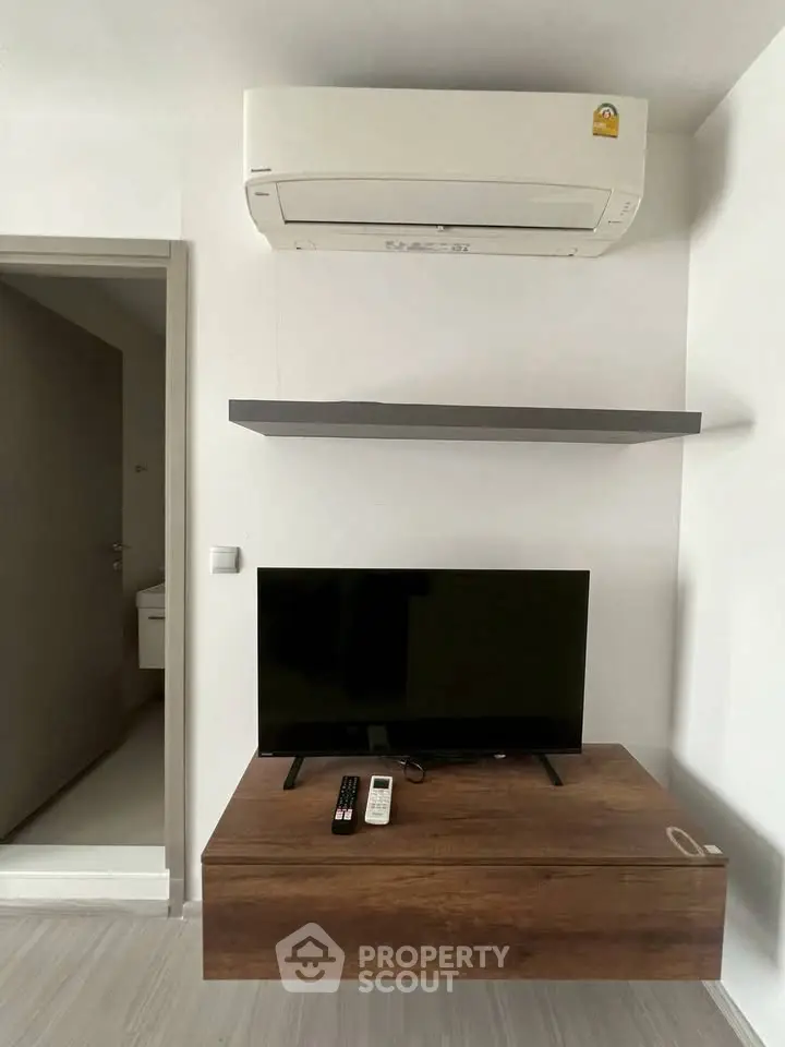Modern living room with air conditioning and sleek TV setup