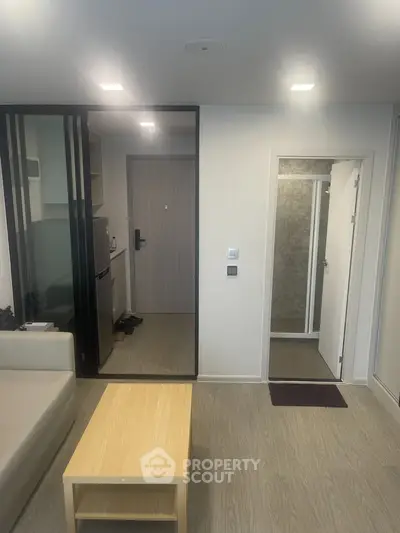 Modern apartment interior with open living area and sleek kitchen design.