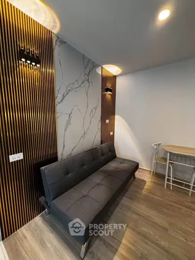 Modern living room with stylish sofa and elegant wall design
