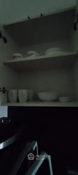 Compact kitchen storage with shelves and white dishware