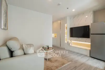 Modern living room with sleek design, featuring a comfortable sofa, stylish TV setup, and elegant decor.