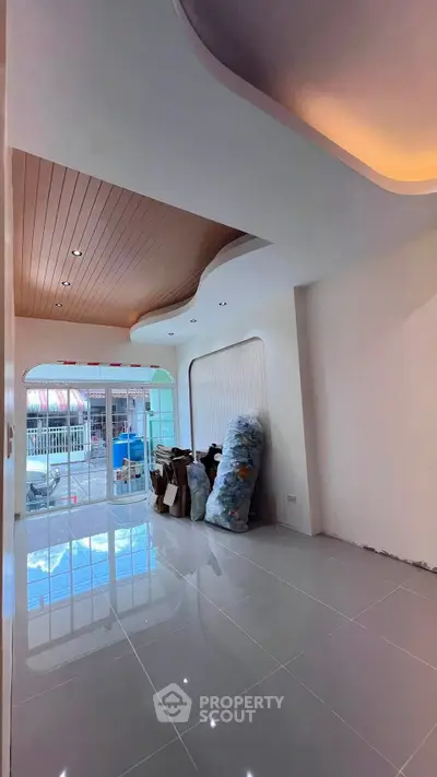 Modern interior space with stylish ceiling design and glossy tiled floor, perfect for a chic urban lifestyle.