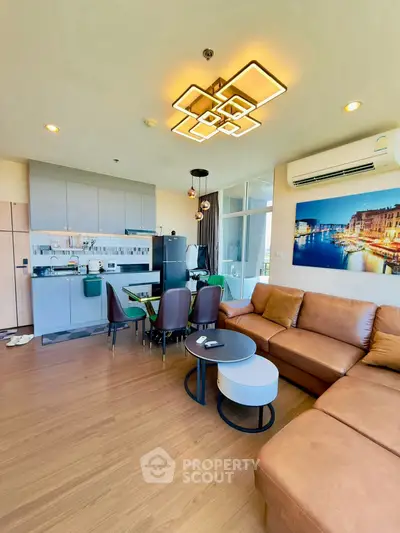 Modern open-layout living room with stylish lighting and leather sofa
