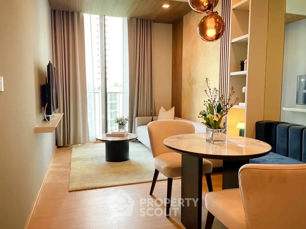 Modern living room with elegant decor and large windows in a stylish apartment.