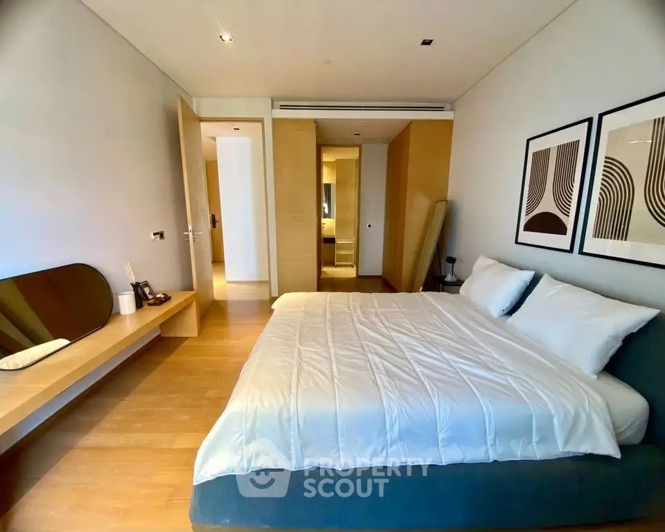 Spacious modern bedroom with stylish decor and ample natural light