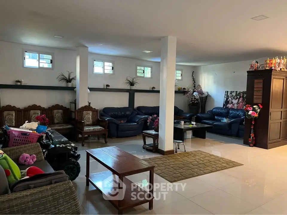 Spacious living room with elegant seating and natural light, perfect for family gatherings.