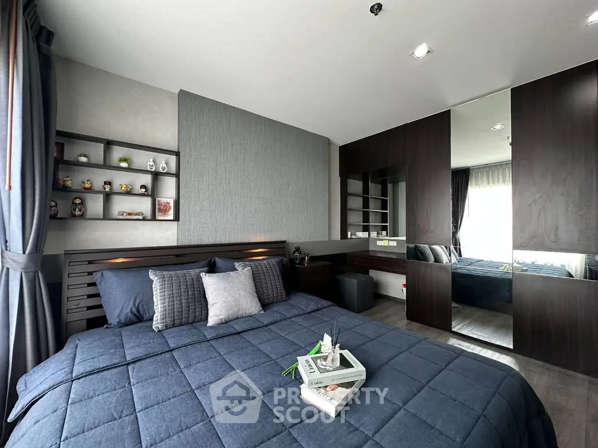 Modern bedroom with stylish decor and ample storage in a contemporary apartment.