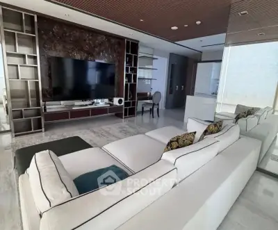 Luxurious modern living room with large sectional sofa and sleek entertainment center
