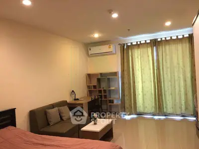 Cozy studio apartment with modern furnishings and ample natural light.