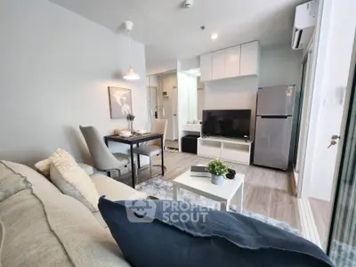 Modern living room with stylish decor and open kitchen layout in a cozy apartment.