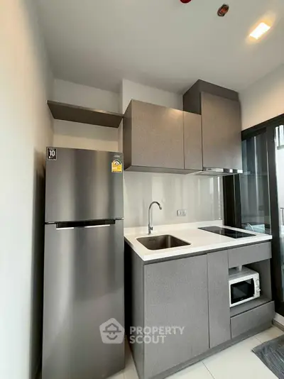 Modern compact kitchen with sleek cabinets and stainless steel appliances
