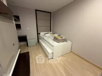 Modern minimalist bedroom with sleek design and wooden flooring