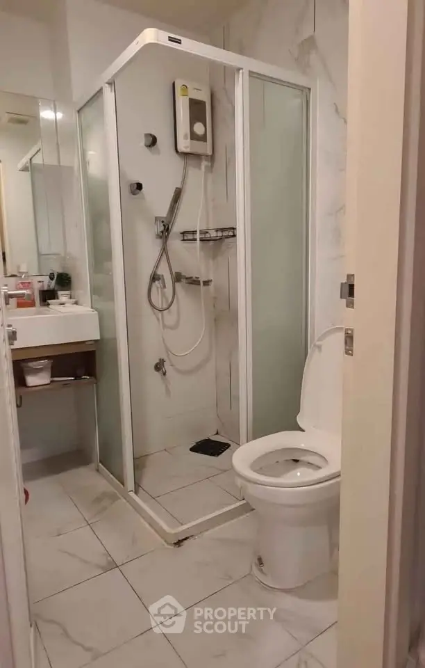 Modern bathroom with glass shower enclosure and sleek fixtures