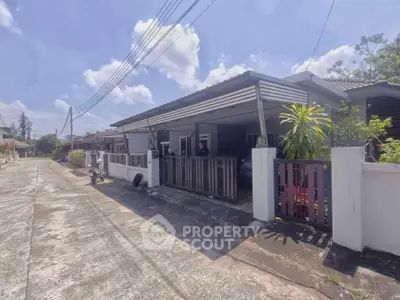 Charming single-story house with a spacious driveway and lush greenery in a serene neighborhood.