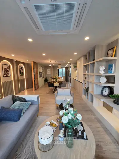 Modern open-concept living room with stylish decor and ample natural light