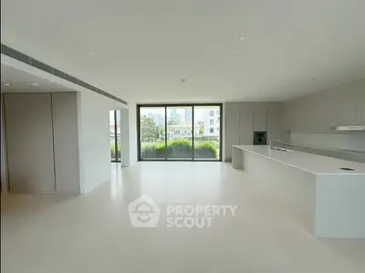 Spacious modern kitchen with open layout and large windows offering city views.