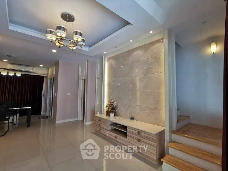 Elegant living room with modern lighting and stylish staircase