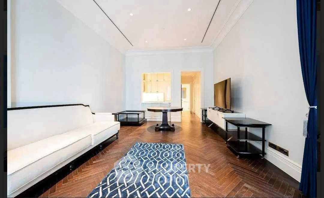 Spacious living room with elegant herringbone flooring and modern furnishings