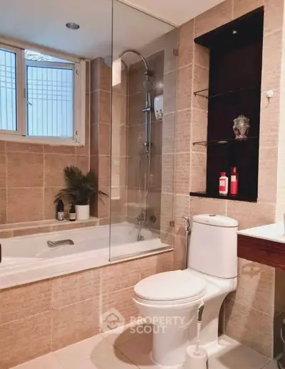 Modern bathroom with bathtub and shower, elegant tiles, and natural light.