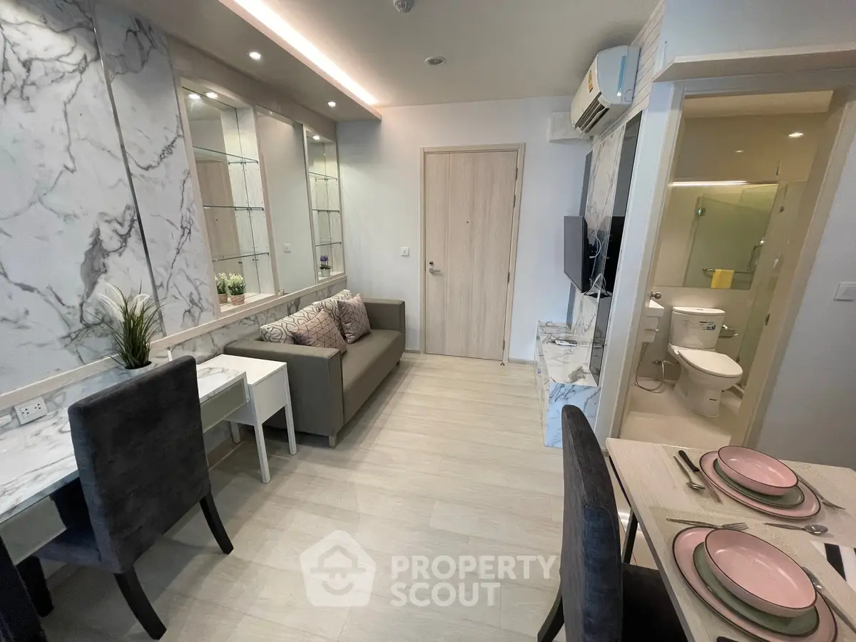 Modern living room with elegant decor and open layout, featuring a cozy dining area and stylish furnishings.