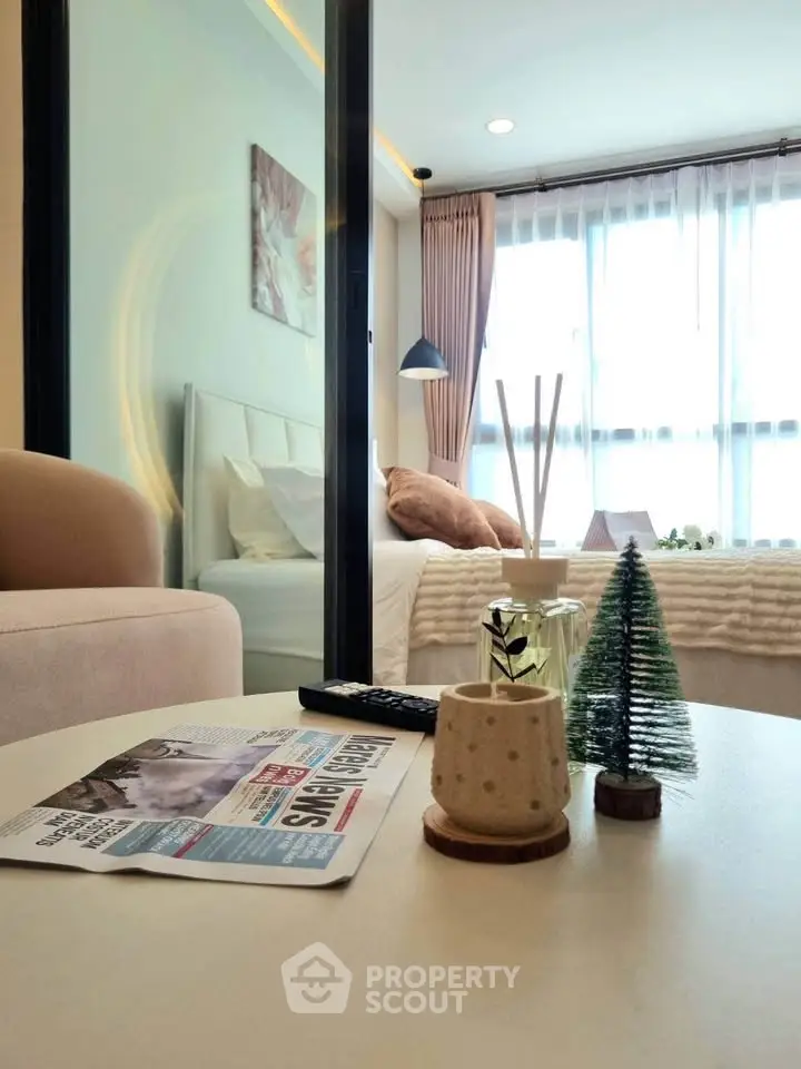Modern bedroom with cozy decor and natural light, featuring a stylish table setup and elegant furnishings.
