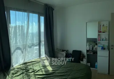 Cozy bedroom with large window and modern decor