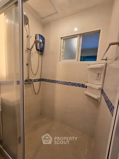Modern bathroom with glass shower enclosure and tiled walls