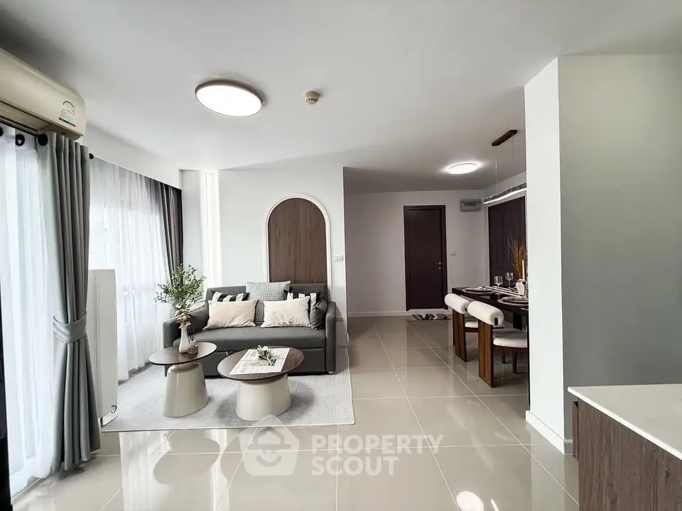 Modern living room with elegant dining area and stylish decor