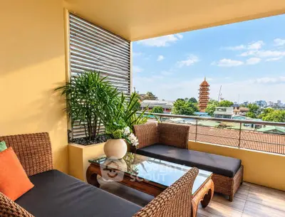 Charming balcony with wicker furniture and stunning city view