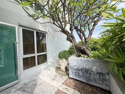 Charming balcony with lush greenery and modern design, perfect for relaxation and outdoor enjoyment.