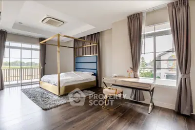 Luxurious bedroom with elegant decor and large windows offering natural light.