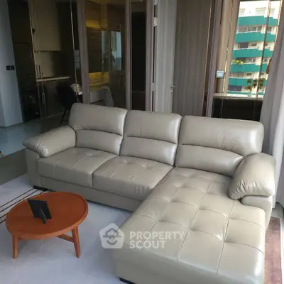 Modern living room with sleek leather sectional sofa and stylish coffee table, perfect for urban living.