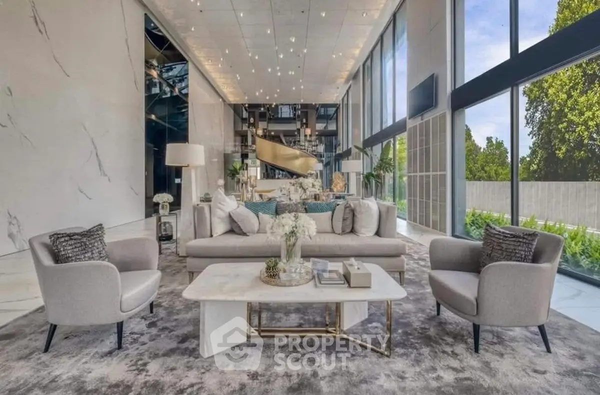 Luxurious modern living room with high ceilings and large windows offering stunning views.