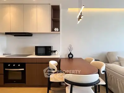 Modern kitchen and dining area with sleek design and cozy seating