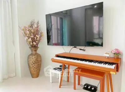 Stylish living room with modern TV and elegant piano setup, perfect for entertainment and relaxation.