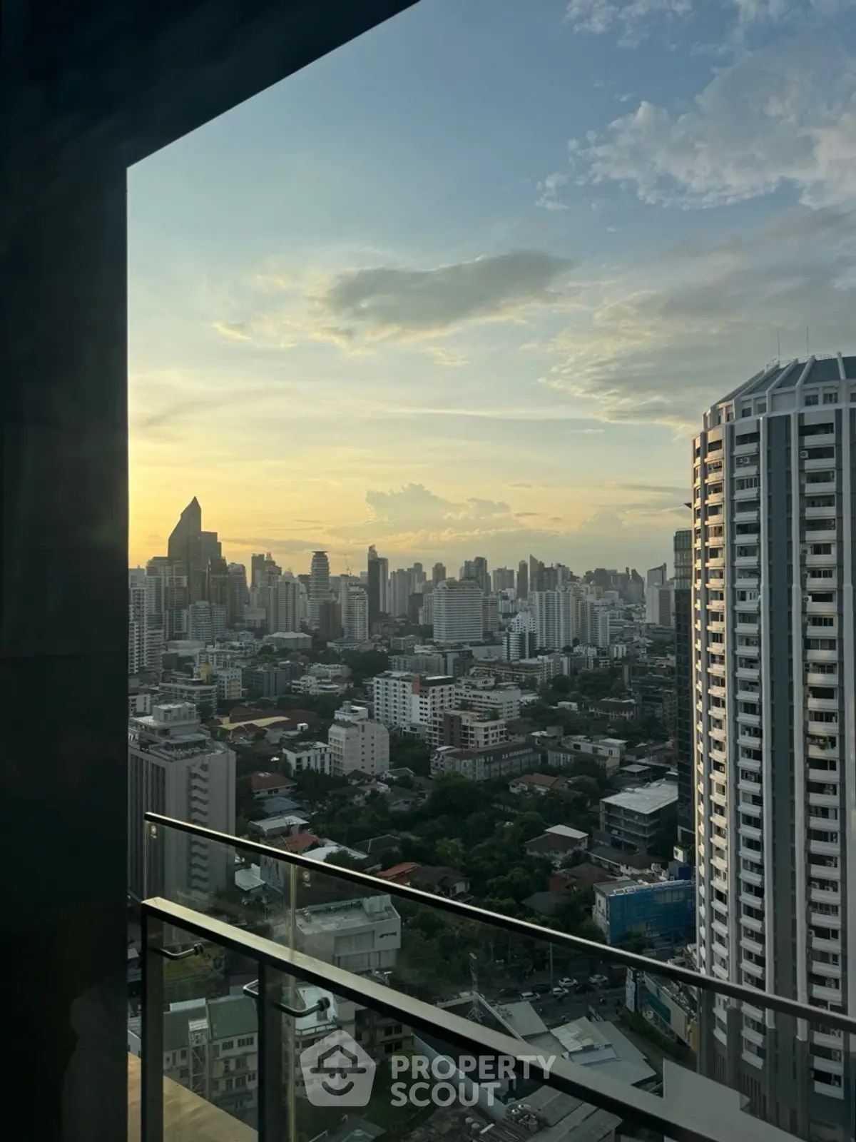 Stunning cityscape view from high-rise balcony at sunset