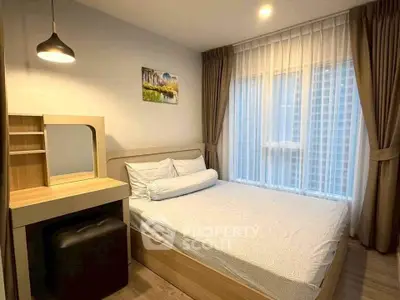 Cozy bedroom with modern decor and large window with elegant curtains.