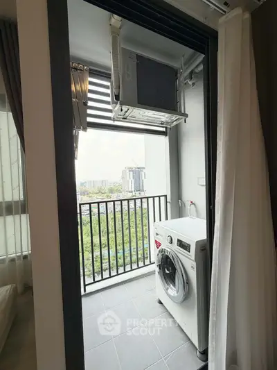 Modern apartment balcony with washing machine and city view, perfect for urban living.