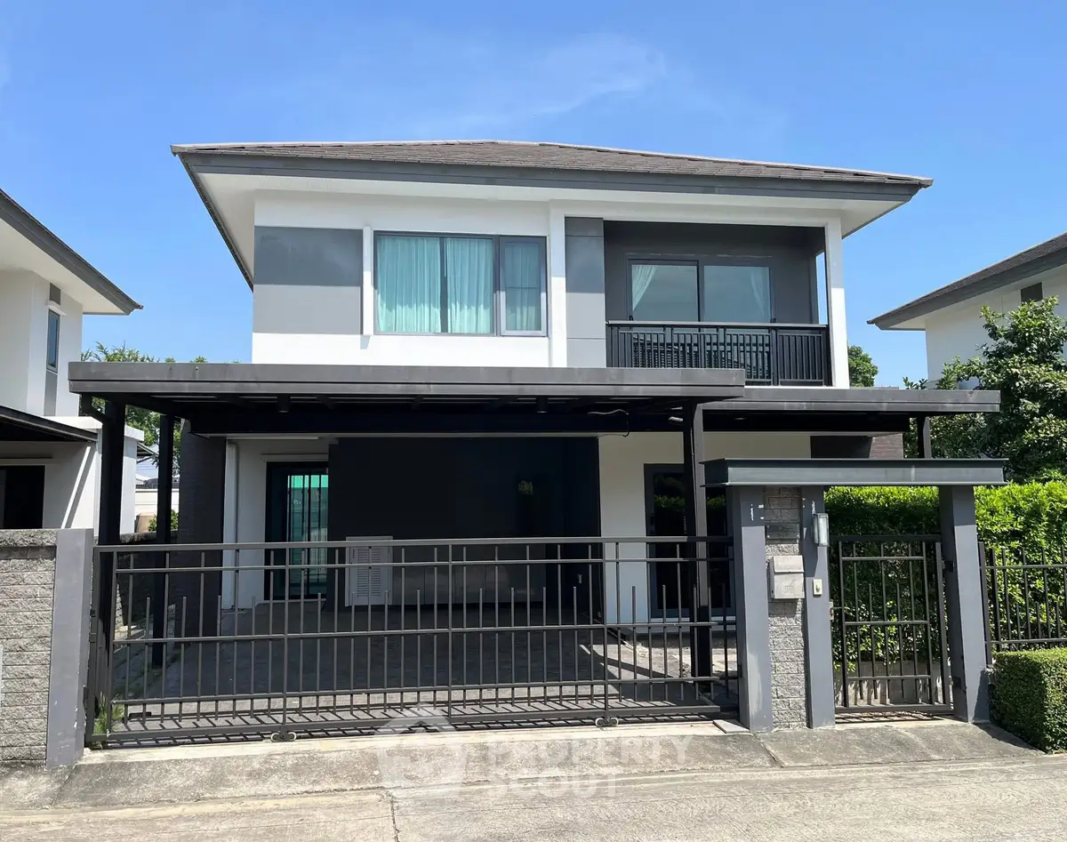 Modern two-story house with sleek design and spacious driveway in a serene neighborhood.