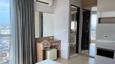 Modern bedroom with city view, featuring a sleek vanity and air conditioning.